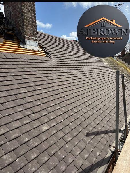 Newly installed plain tile roof next to chimney stack