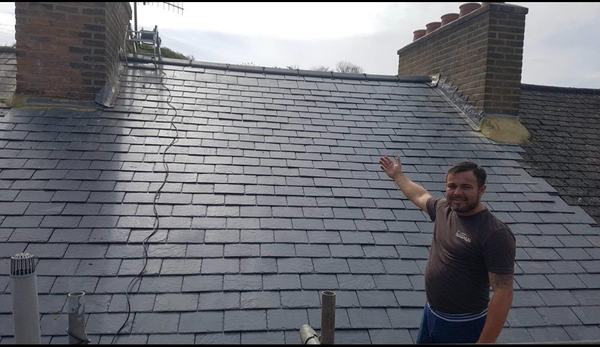 Completed slate roof with lead flashing and ridge on terraced property