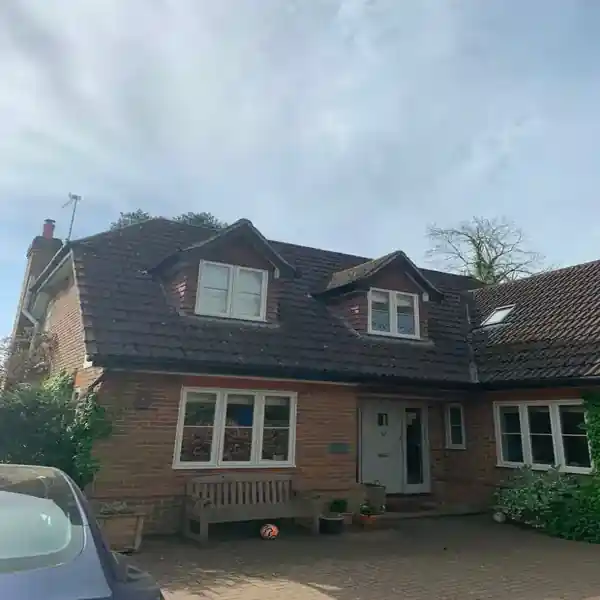 Traditional tiled roof with dormer windows on a detached cottage